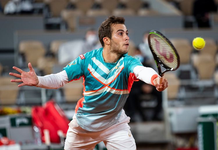 Hugo Gaston stretches for a backhand volley at Roland Garros 2020
