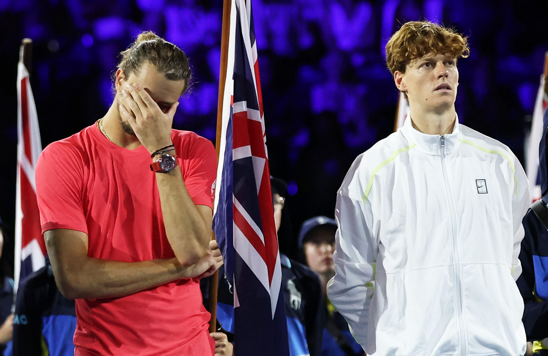 Alexander Zverev looks disconsolate (left) whilst Jannik Sinner waits for the trophy (right)
