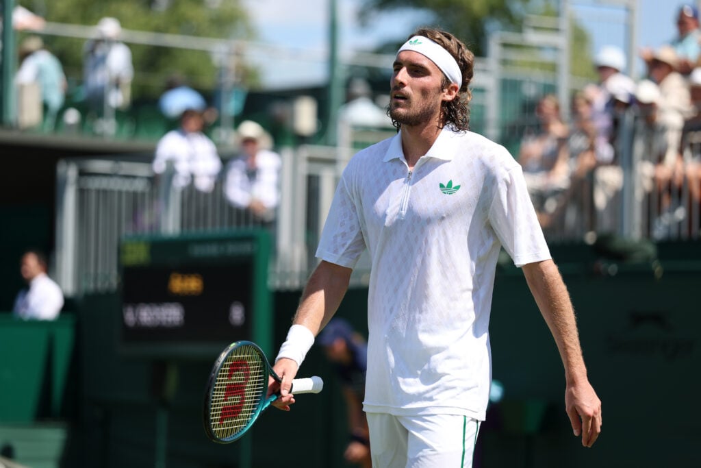 Stefanos Tsitsipas of Greece reacts as he retires against Valentin Royer of France during the Gentlemen's Singles first round match on day one of The Championships Wimbledon 2025 at All England Lawn Tennis and Croquet Club on June 30, 2025 in London, England.