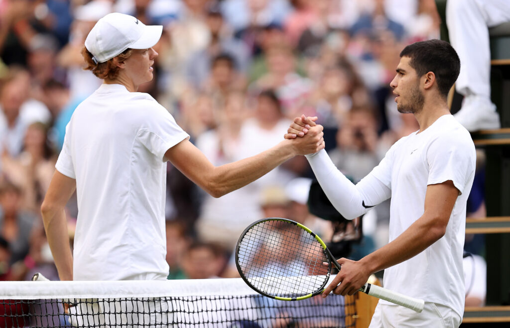 Carlos Alcaraz and Jannik Sinner shake hands after their match at Wimbledon in 2022