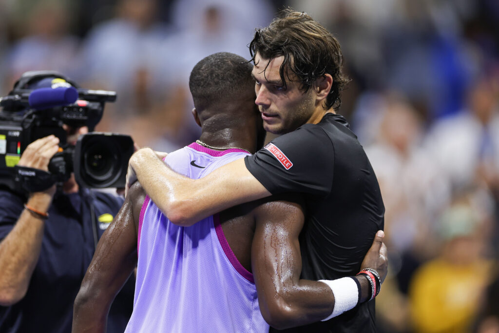 Taylor Fritz (R) of the United States embraces Frances Tiafoe of the United States after defeating him in their Men's Singles Semifinal match on Day Twelve of the 2024 US Open at USTA Billie Jean King National Tennis Center on September 06, 2024 in the Flushing neighborhood of the Queens borough of New York City.