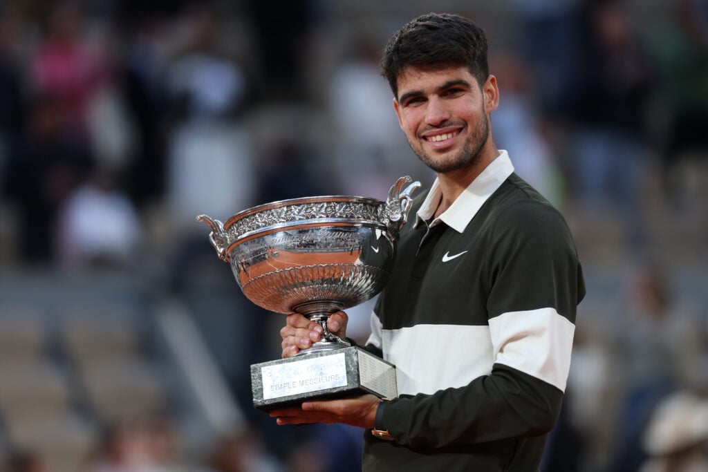 Carlos Alcaraz of Spain holds the Coupe des Mousquetaires trophy following his victory over Jannik Sinner of Italy in the Men’s Singles Final match on Day Fifteen of the 2025 French Open at Roland Garros on June 08, 2025 in Paris, France.