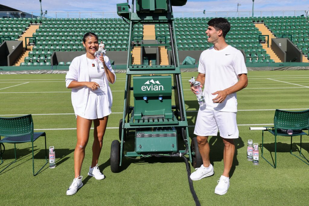 Carlos Alcaraz and Emma Raducanu laugh during an Evian event
