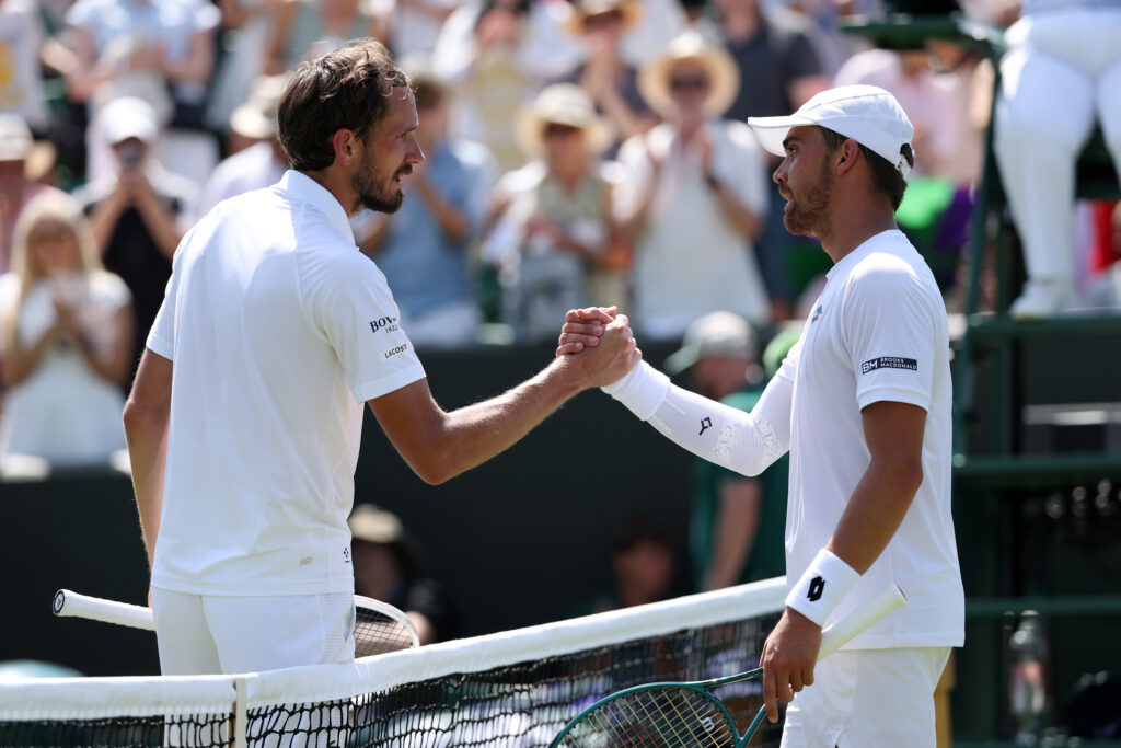 Daniil Medvedev (L) shakes hands with Benjamin Bonzi of France following his defeat during the Gentlemen's' Singles first round match on day one of The Championships Wimbledon 2025 at All England Lawn Tennis and Croquet Club on June 30, 2025 in London, England.