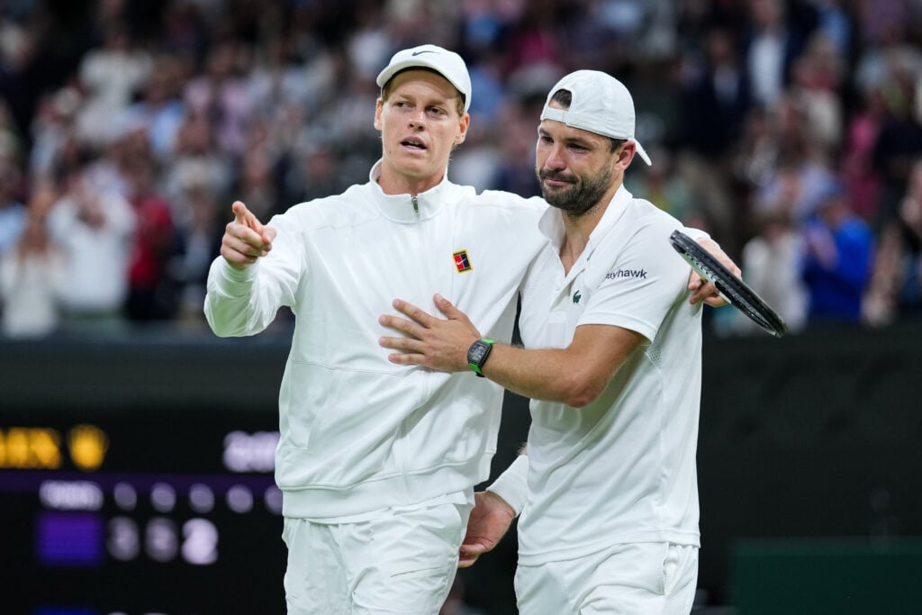 Jannik Sinner (L) of Italy greets Grigor Dimitrov of Bulgaria after Dimitrov retired due to injury in the Gentlemen's Singles Fourth Round match on day eight of The Championships Wimbledon 2025 at All England Lawn Tennis and Croquet Club on July 07, 2025 in London, England.