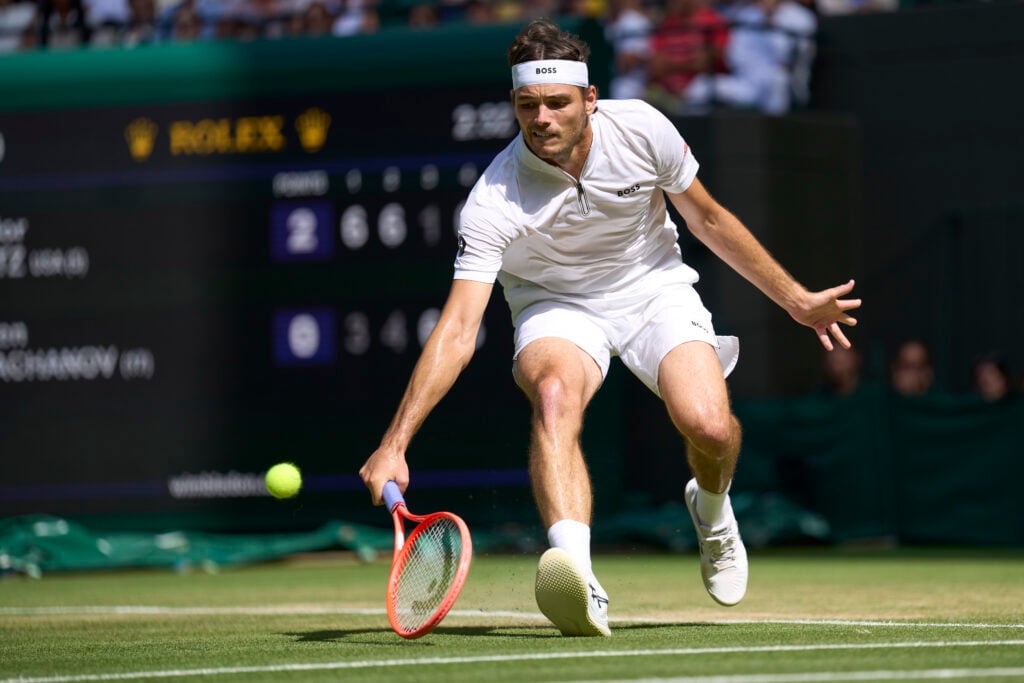 Taylor Fritz of the United States plays a backhand pick up against Karen Kachanov during the Gentlemen's quarter-finals round match on Number One Court on day nine of The Championships Wimbledon 2025 at All England Lawn Tennis and Croquet Club on July 8, 2025 in London, England.