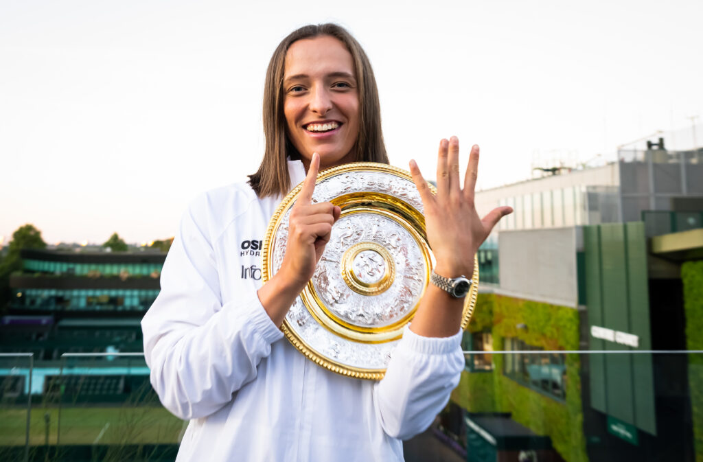 Iga Swiatek of Poland poses with six fingers representing her six Grand Slam wins after defeating Amanda Anisimova of the United States in the womens singles final on Day Thirteen of The Championships Wimbledon 2025 at All England Lawn Tennis and Croquet Club on July 12, 2025 in London, England