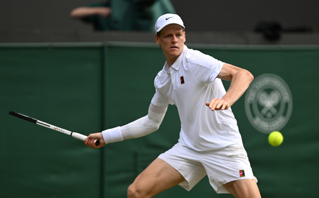 Jannik Sinner of Italy plays a forehand against Ben Shelton of United States during the Gentlemen's Singles quarter-final match on day ten of The Championships Wimbledon 2025 at All England Lawn Tennis and Croquet Club on July 09, 2025 in London, England.