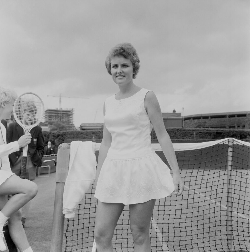 Australian professional tennis player Lesley Turner Bowrey pictured by the net on a court at the All England Lawn Tennis and Croquet Club in Wimbledon, London on 25th June 1965.