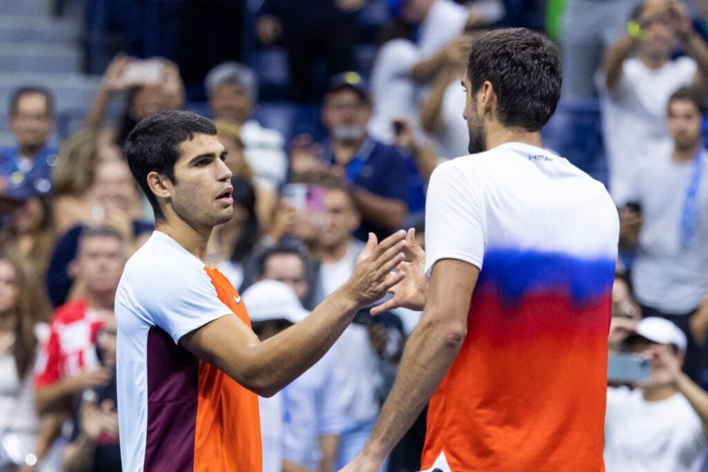 Carlos Alcaraz of Spain, left, shakes hands with Marin Cilic of Croatia after Alcaraz won during their Men’s Singles Fourth Round match on Day Eight of the 2022 US Open