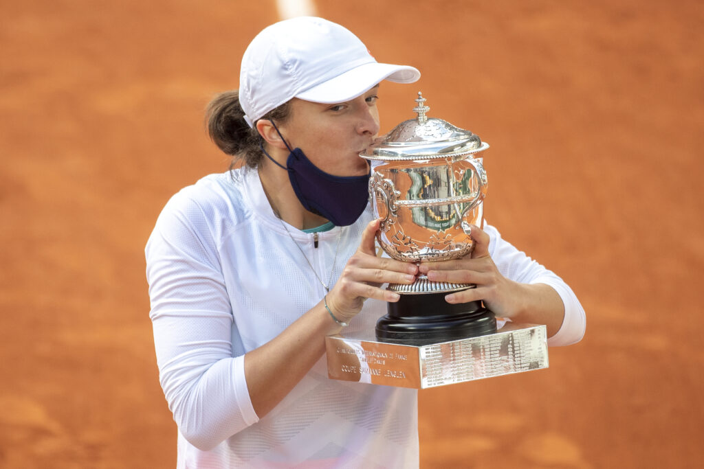 Iga Swiatek of Poland kisses the trophy after defeating Sofia Kenin of the United States in the Singles Final on Court Philippe-Chatrier during the French Open Tennis Tournament at Roland Garros on October 10th 2020 in Paris, France.