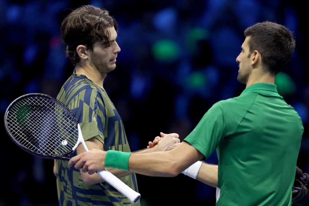 Novak Djokovic and Taylor Fritz shake hands after their match at the 2023 ATP Finals.