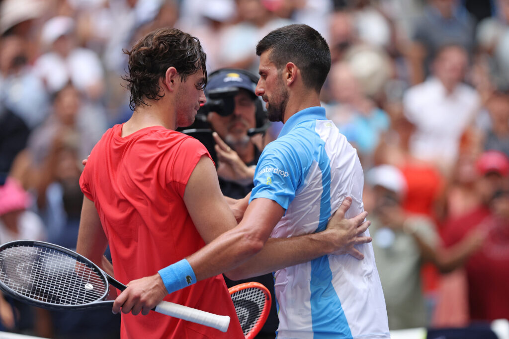 ovak Djokovic of Serbia meets Taylor Fritz of the United States at the net after winning their Men's Singles Quarterfinal match on Day Nine of the 2023 US Open