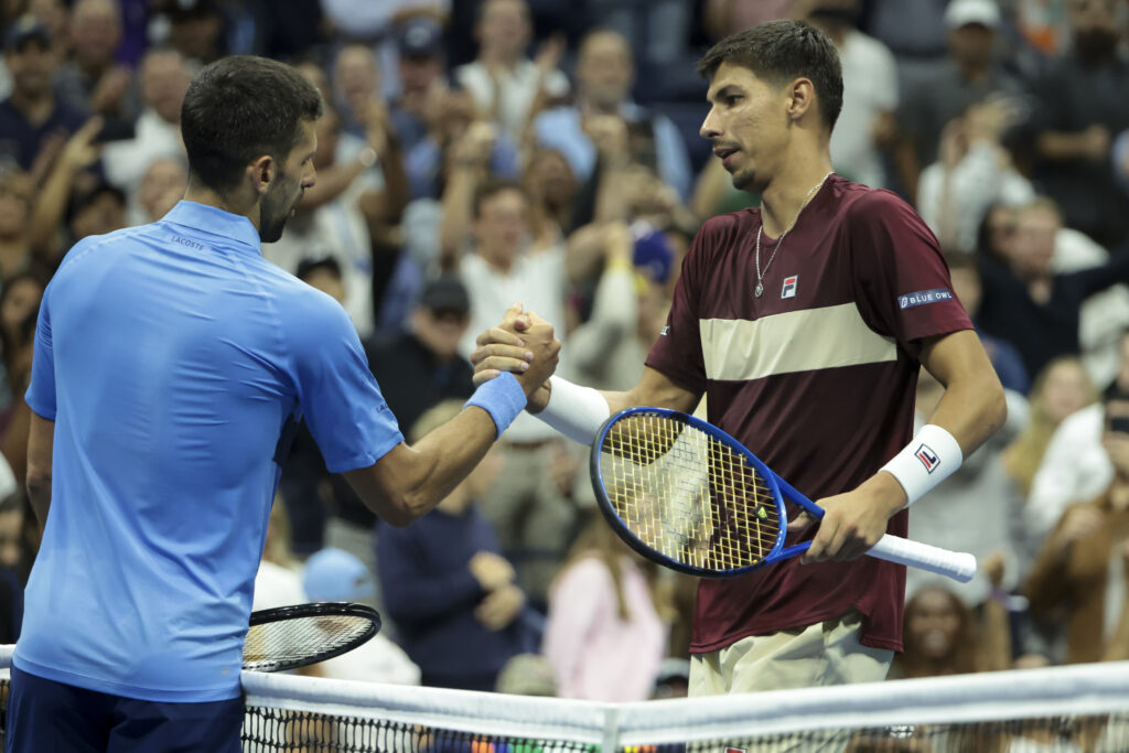 Alexei Popyrin of Australia (R) shakes hands with Novak Djokovic of Serbia after his victory during their Men's Singles Third Round match on Day Five of the 2024 US Open at USTA Billie Jean King National Tennis Center on August 30, 2024 in the Flushing neighborhood of the Queens borough of New York City.