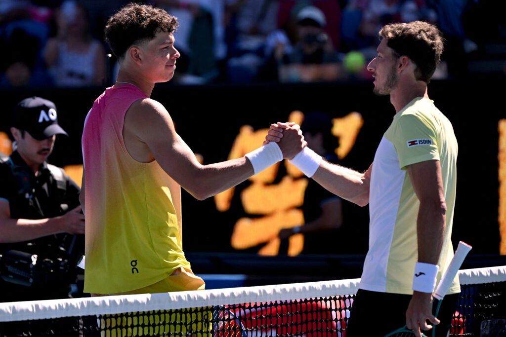 USA's Ben Shelton (L) shakes hands with Spain's Pablo Carreno Busta after their men's singles match on day five of the Australian Open tennis tournament in Melbourne on January 16, 2025.