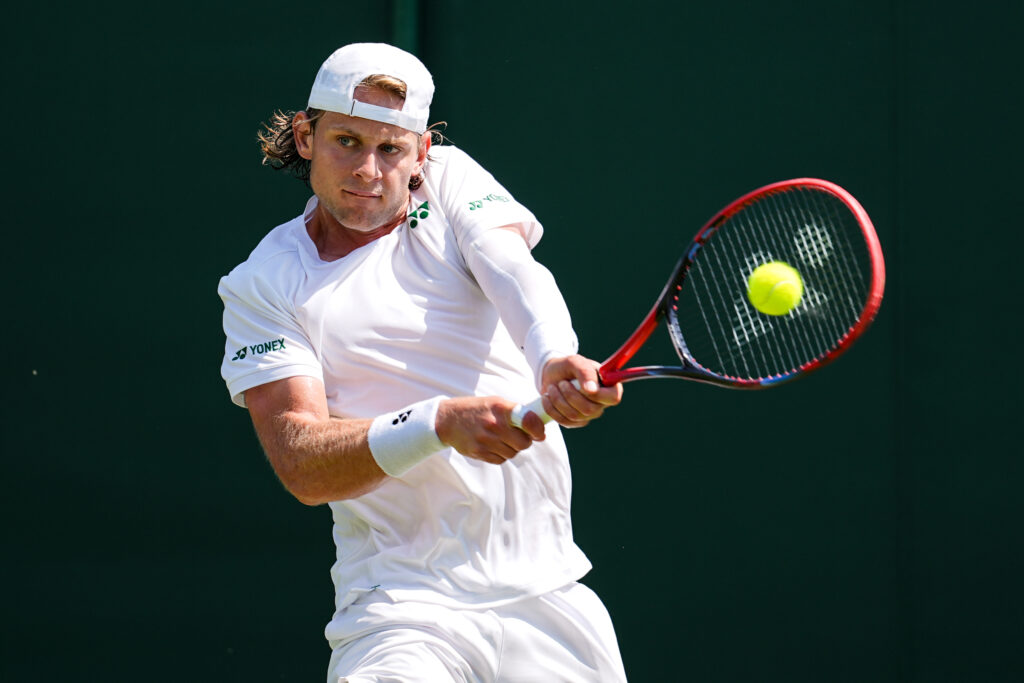 Zizou Bergs of Belgium plays a backhand in the Gentlemen's Singles First Round match against Lloyd Harris of South Africa on day one of The Championships Wimbledon 2025 at All England Lawn Tennis and Croquet Club on June 30, 2025 in London, England.