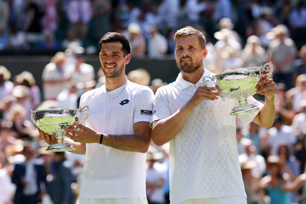Julian Cash of Great Britain and Lloyd Glasspool of Great Britain pose for a photo with the Gentlemen's Doubles Trophies following victory against Rinky Hijikata of Australia and David Pel of Netherlands during the Gentlemen's Doubles Final on day thirteen of The Championships Wimbledon 2025 at All England Lawn Tennis and Croquet Club on July 12, 2025 in London, England.