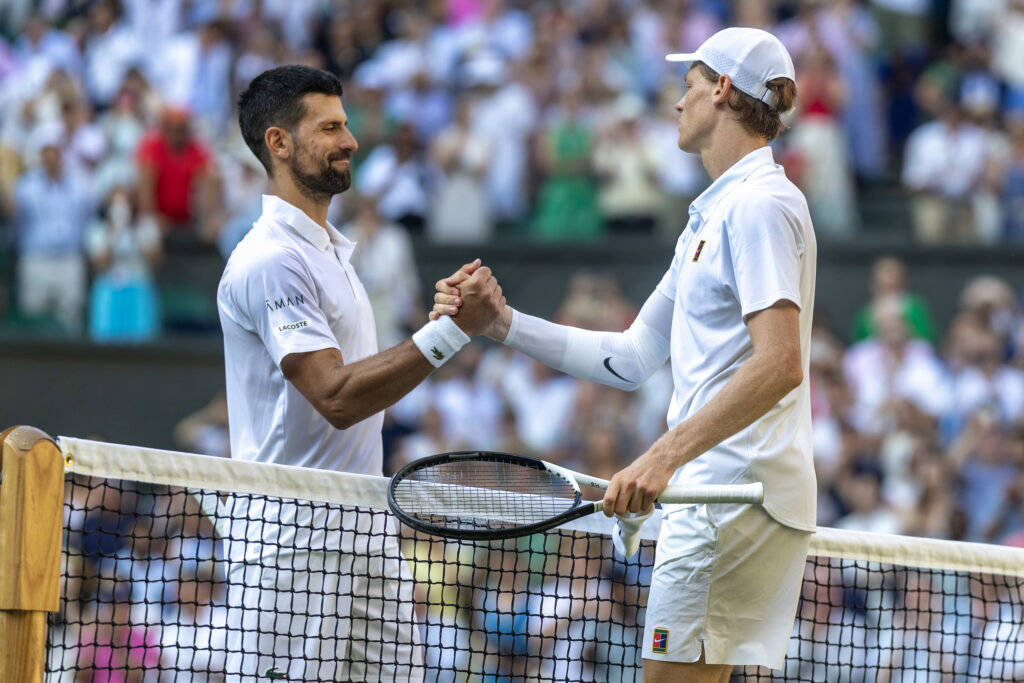 Winner Jannik Sinner of Italy and Novak Djokovic of Serbia embrace at the net after their Semi-Final match of the Gentlemen's Singles Competition on Centre Court during the Wimbledon Lawn Tennis Championships at the All England Lawn Tennis and Croquet Club at Wimbledon on July 11th, 2025, in London, England.