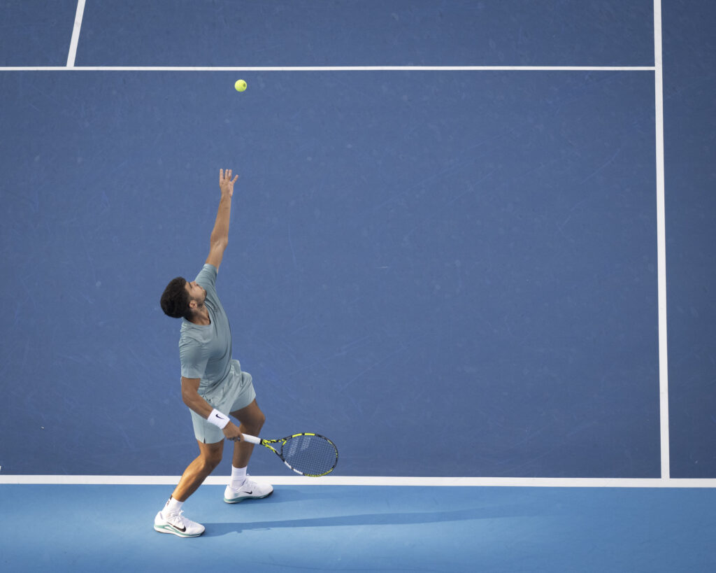 Carlos Alcaraz serves
