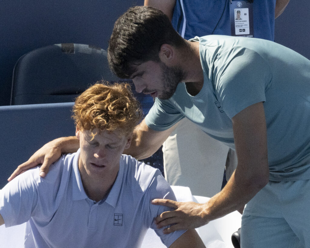 Carlos Alcaraz helps an unwell Jannik Sinner at the Cincinnati Open final