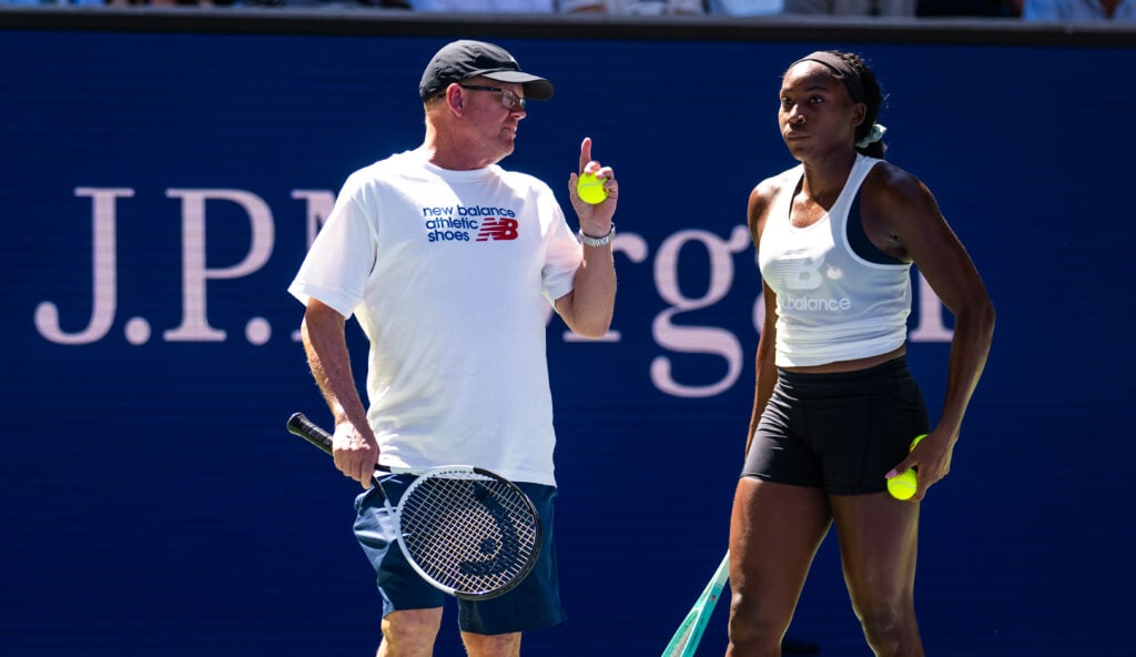 Coco Gauff of the United States listens to biomechanics expert Gavin MacMillan during practice ahead of the US Open at USTA Billie Jean King National Tennis Center on August 22, 2025 in New York City