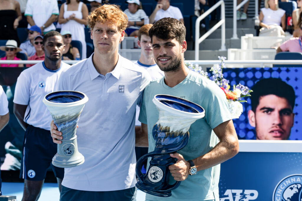 Carlos Alcaraz of Spain and Jannik Sinner of Italy pose with their trophies after Jannik Sinner retired from the men's final of the Cincinnati Open at the Lindner Family Tennis Center on August 18, 2025 in Mason, Ohio. (