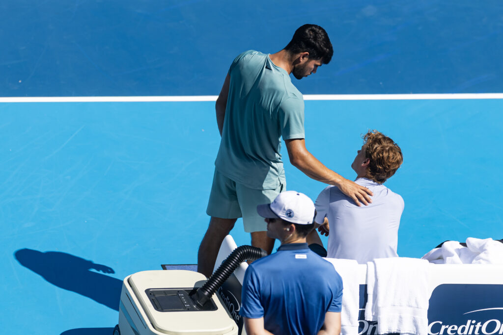 Carlos Alcaraz of Spain comforts Jannik Sinner of Italy after Sinner retired during the final of the men’s singles at the Cincinnati Open at the Lindner Family Tennis Center on August 18, 2025 in Mason, Ohio.