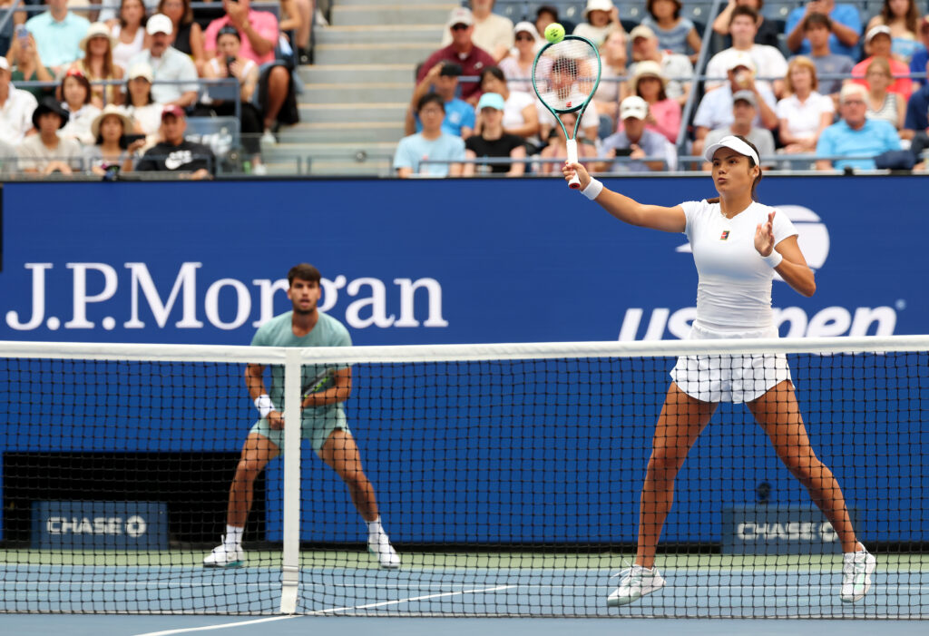 Emma Raducanu attempts to hit a volley during their 2025 US Open - Mixed Doubles first round alongside Carlos Alcaraz