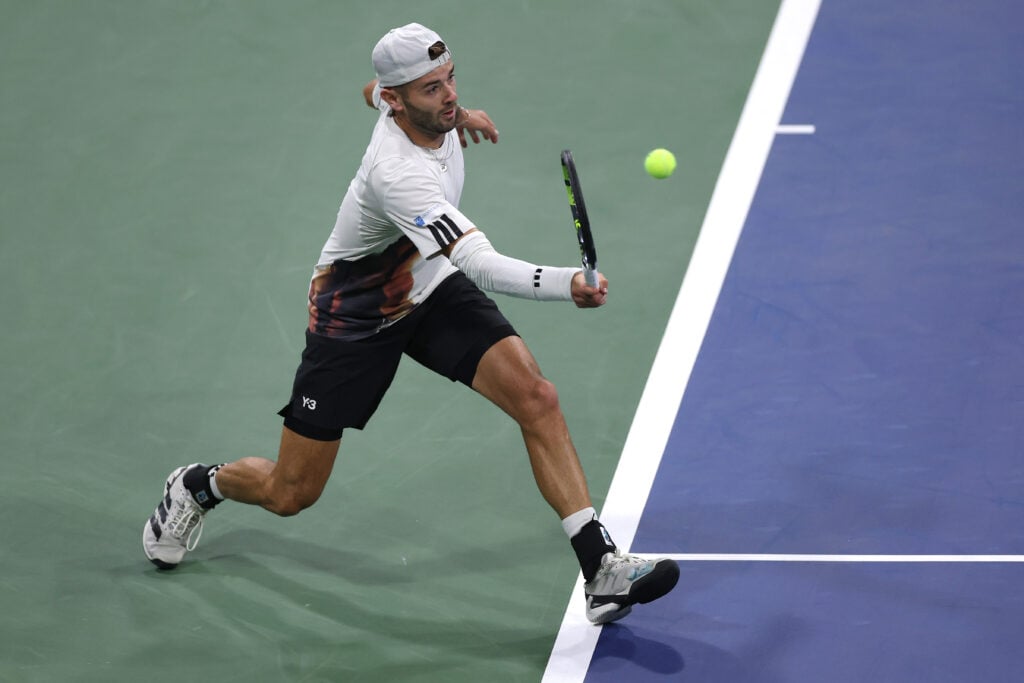 Jacob Fearnley of Great Britain returns against Roberto Bautista Agut of Spain during their Men's Singles First Round match on Day Three of the 2025 US Open