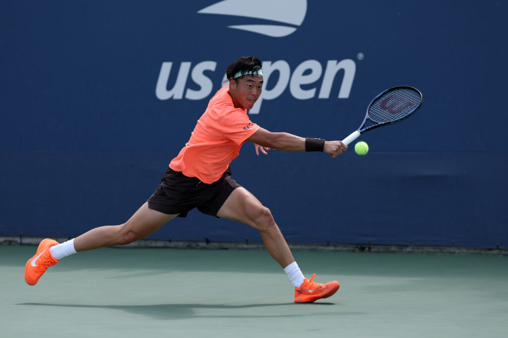Coleman Wong stretches for a backhand