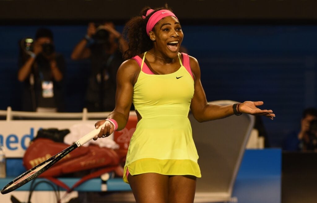 Serena Williams smiles and puts her arms out