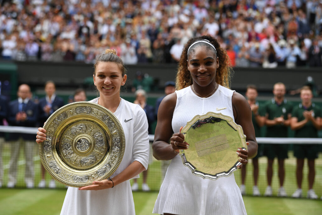 Romania's Simona Halep (L) poses with the Venus Rosewater Dish trophy (L) and US player Serena Williams poses with the runners up trophy after Halep won their women's singles final on day twelve of the 2019 Wimbledon Championships at The All England Lawn Tennis Club in Wimbledon, southwest London, on July 13, 2019.