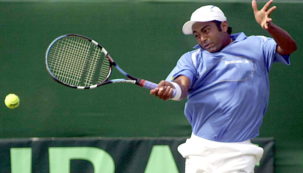 India's Leander Paes hits a return to Robert Cheyne of New Zealand during their singles Davis Cup match in Calcutta, 06 April 2003. Paes won 6-2, 6-1. India qualified for the Davis Cup world group playoff with a convincing 4-1 victory over New Zealand in the Asia-Oceania Group One second round tie.