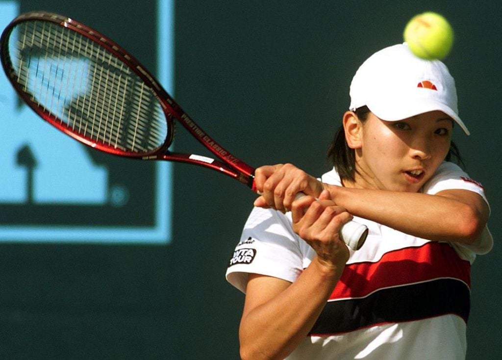 Miho Saeki of Japan follows through on a backhand during her match against Nathalie Tauziat of France during Evert Cup play 06 March in Indian Wells, California. Saeki lost to the 8th ranked Tauziat 6-1, 7-6 (7-3), 6-3.
