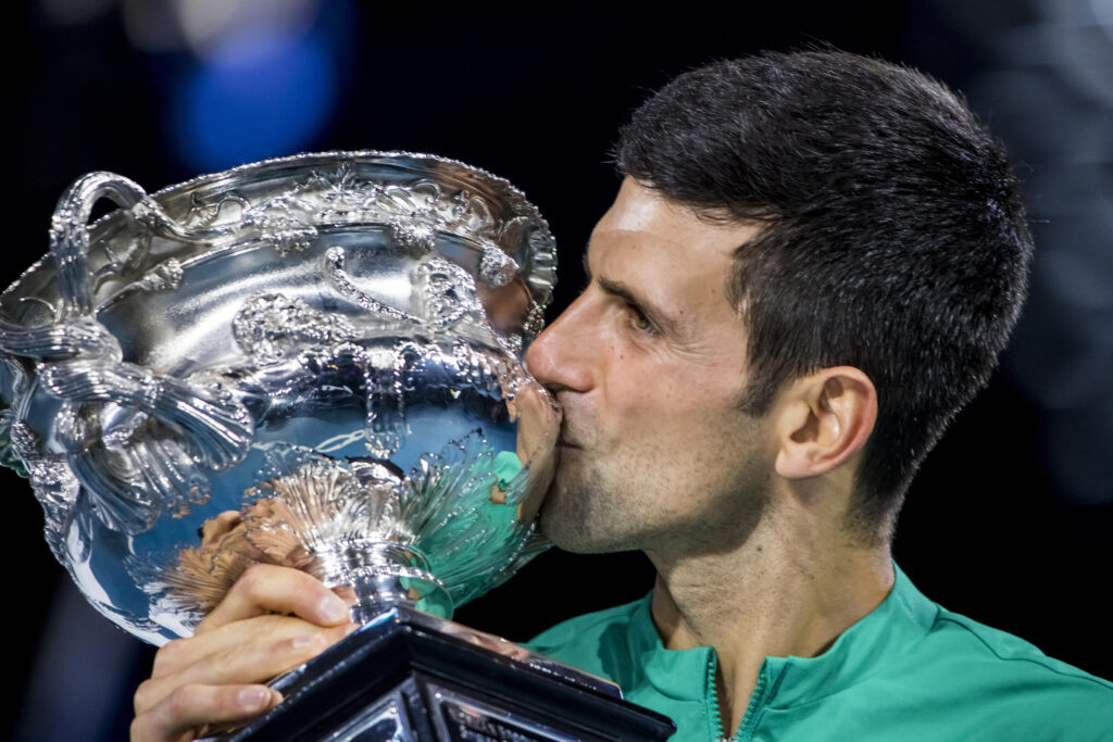 Novak Djokovic kisses the Australian Open trophy