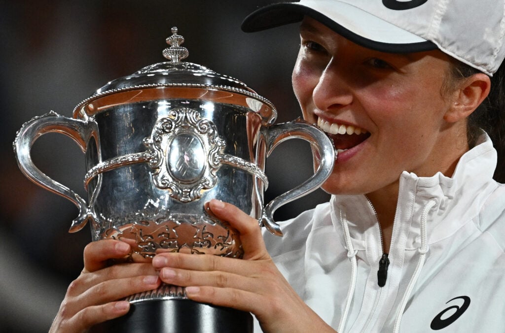 Poland's Iga Swiatek poses with the trophy after winning against US' Coco Gauff at the end of their women's single final match on day fourteen of the Roland-Garros Open tennis tournament at the Court Philippe-Chatrier in Paris on June 4, 2022. Iga Swiatek cruised to her second French Open title by dominating teenager Coco Gauff in the final as the world number one claimed her 35th successive victory.