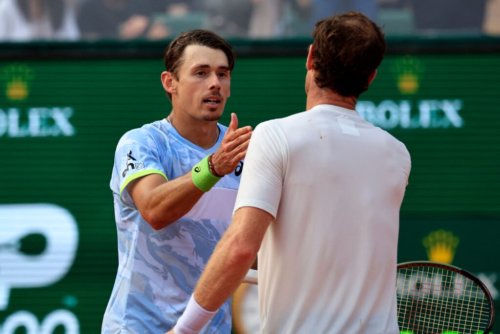 Australia's Alex De Minaur (L) shakes hands with Britain's Andy Murray after winning their Monte-Carlo ATP Masters Series tournament round of 64 tennis match in Monaco on April 10, 2023.