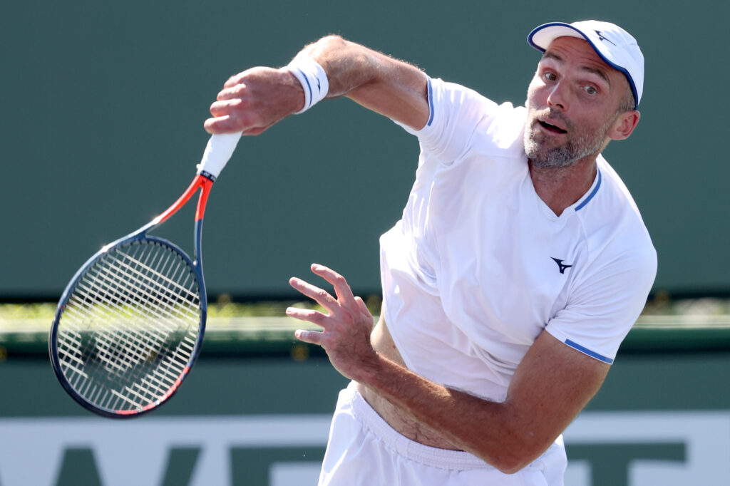 Ivo Karlovic of Croatia serves to Brayden Schnur of Canada during qualifying for the BNP Paribas Open at the Indian Wells Tennis Garden on October 05, 2021 in Indian Wells, California.