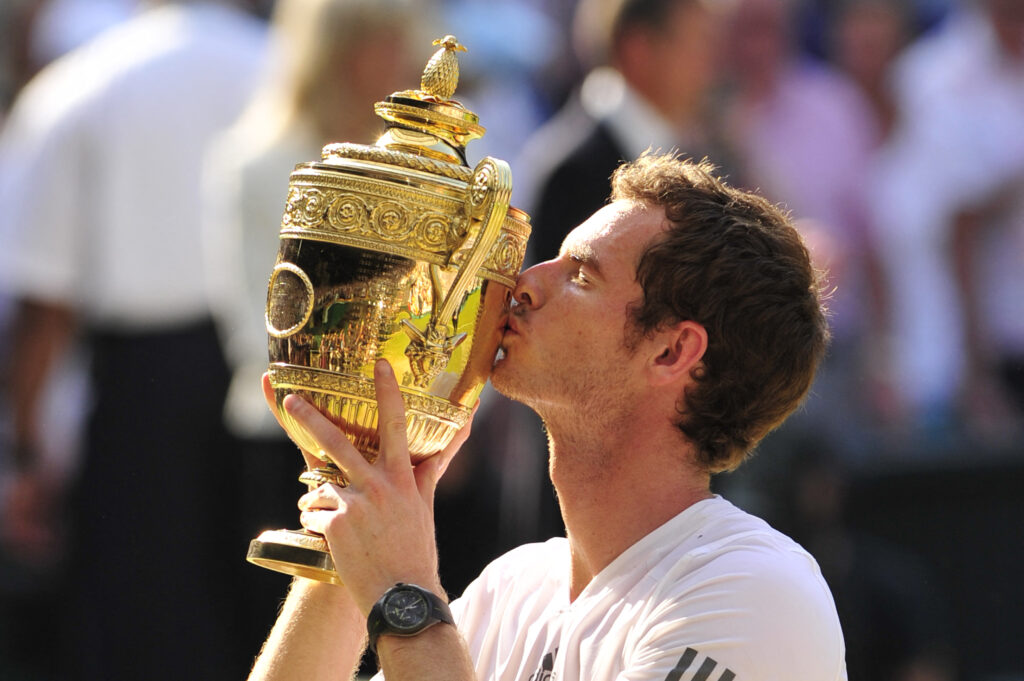 Britain's Andy Murray raises the winner's trophy after beating Serbia's Novak Djokovic in the men's singles final on day thirteen of the 2013 Wimbledon Championships tennis tournament at the All England Club in Wimbledon, southwest London, on July 7, 2013. Murray won 6-4, 7-5, 6-4.