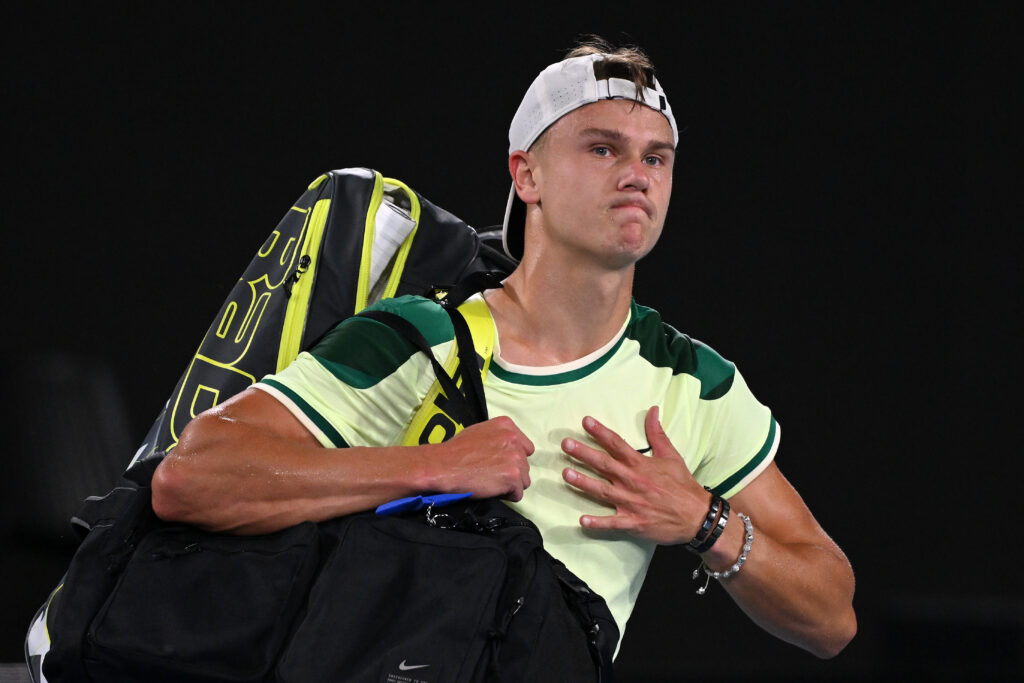 Holger Rune of Denmark looks dejected as he leaves Margaret Court Arena after losing his round two singles match against Arthur Cazaux of France during the 2024 Australian Open at Melbourne Park on January 18, 2024 in Melbourne, Australia