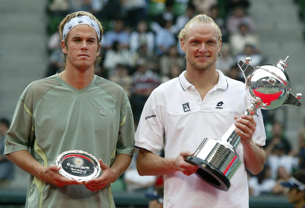 Winner Kenneth Carlsen of Denmark (R) and Magnus Norman of Sweden, pose with trophy nd plaque during an award ceremony for the men's singles final at the Japan Open tennis tournament in Tokyo, 06 October 2002.