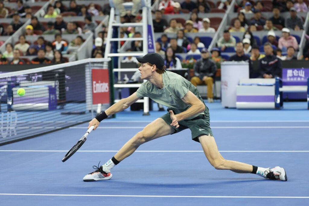 Jannik Sinner stretches for a backhand