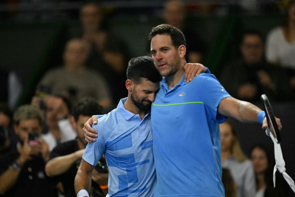 Serbia's Novak Djokovic (L) greets Argentina's Martin del Potro at the end of Del Potro's farewell exhibition tennis match at Arena Parque Roca in Buenos Aires on December 1, 2024.
