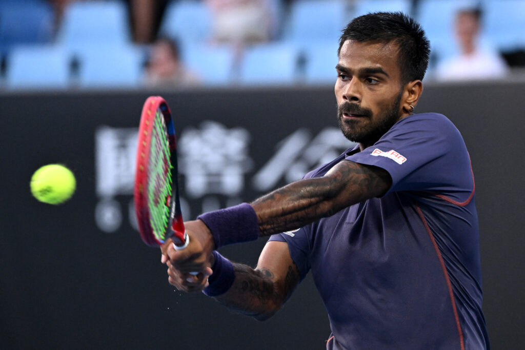 India's Sumit Nagal hits a shot against Czech Republic's Tomas Machac during their men's singles match on day one of the Australian Open tennis tournament in Melbourne on January 12, 2025.