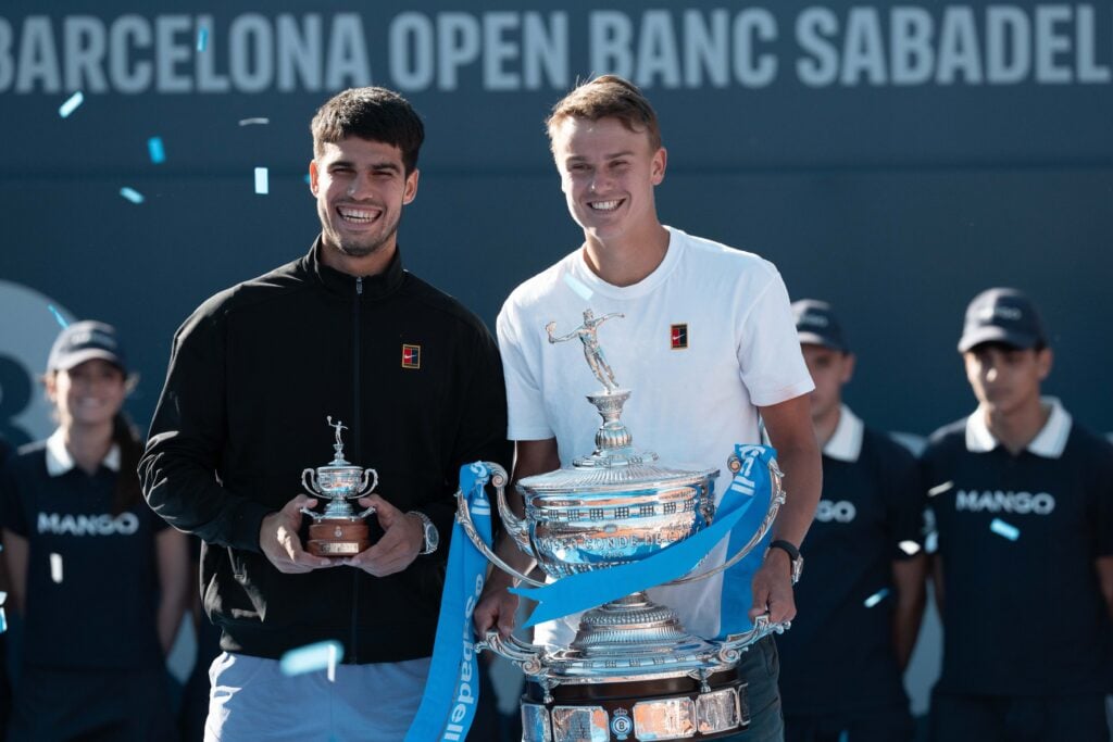 Carlos Alcaraz Garfia Spanish tennis player and Holger Rune Danish tennis player pose for the cameras with their trophies during the final of the ATP 500 Barcelona Open. Holger Rune defeated Carlos Alcaraz in the final of the Barcelona Open. The score was 7-6(6), 6-2.