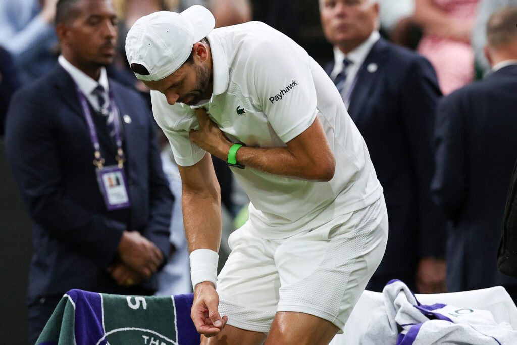 Bulgaria's Grigor Dimitrov reacts after getitng injured during his men's singles fourth round tennis match against Italy's Jannik Sinner on the eighth day of the 2025 Wimbledon Championships at The All England Lawn Tennis and Croquet Club in Wimbledon, southwest London, on July 7, 2025.