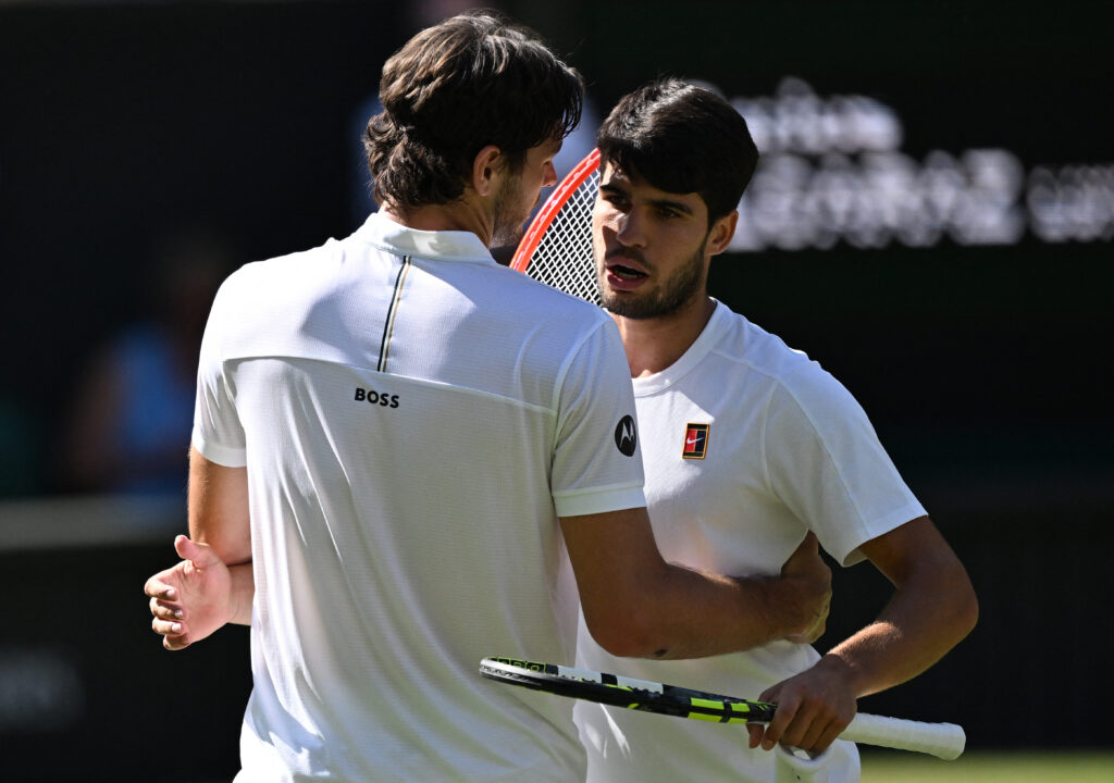 Winner Spain's Carlos Alcaraz (R) hugs US player Taylor Fritz during their men's singles semi-final tennis match on the twelfth day of the 2025 Wimbledon Championships at The All England Lawn Tennis and Croquet Club in Wimbledon, southwest London, on July 11, 2025.