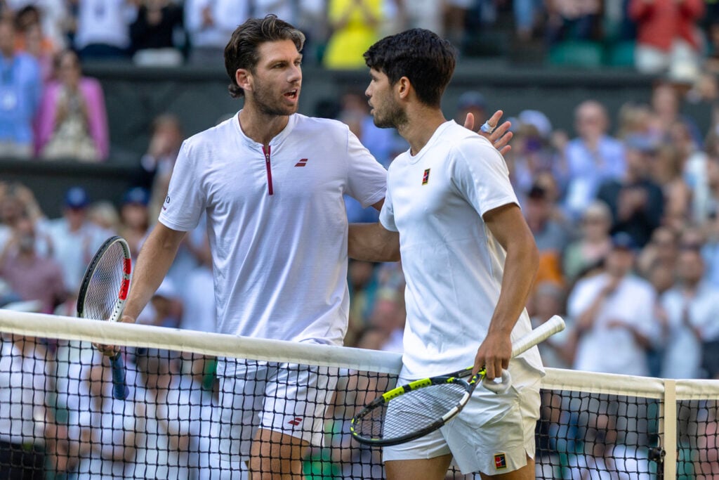 Winner Carlos Alcaraz of Spain and Cameron Norrie of Great Britain embrace at the net after the Quarter-Finals of the Gentlemen's Singles Competition on Centre Court during the Wimbledon Lawn Tennis Championships at the All England Lawn Tennis and Croquet Club at Wimbledon on July 8th, 2025, in London, England.
