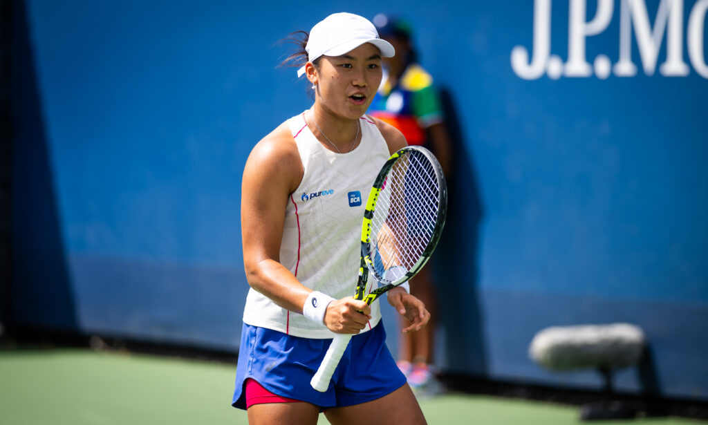Janice Tjen holds out her racket
