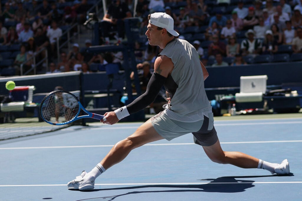 Britain's Jack Draper plays a return to Argentina's Federico Agustin Gomez during their men's singles first round tennis match on day two of the US Open tennis tournament at the USTA Billie Jean King National Tennis Center in New York City, on August 25, 2025.